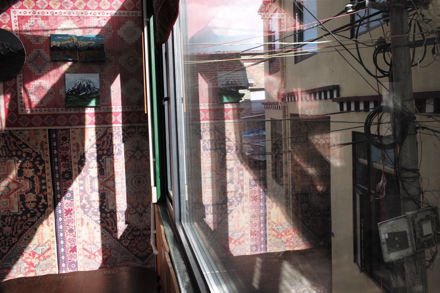 Interior and street reflected through a window