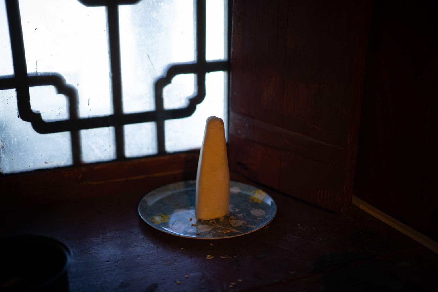 Food on a plate beside a window