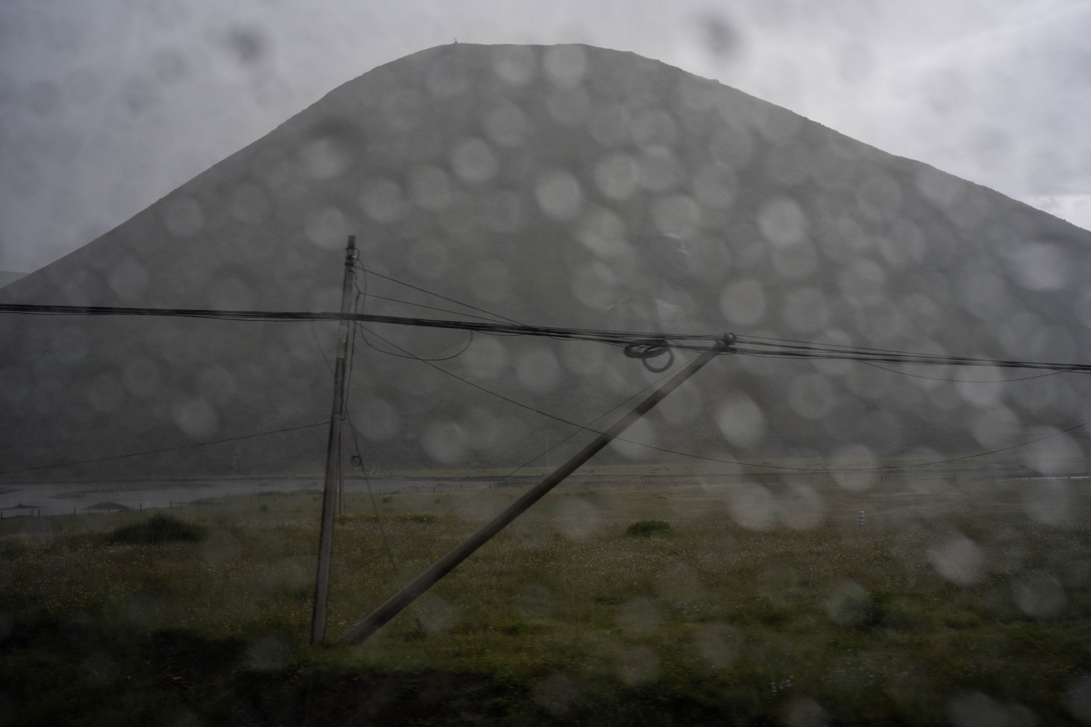 Mountain seen through a rain-covered window