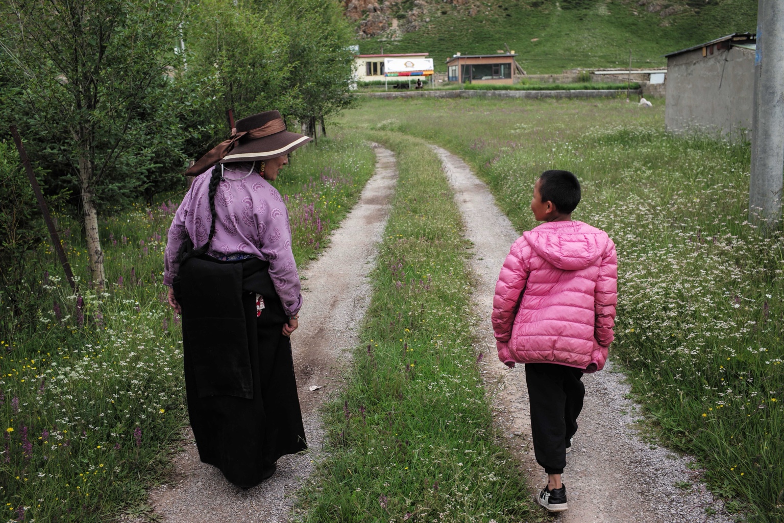 A woman and child walking along a rural path